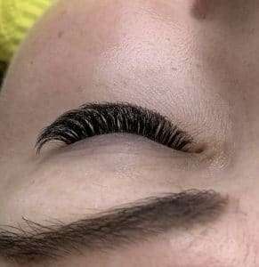 Close-up of eyelash extensions with soft, wispy volume.