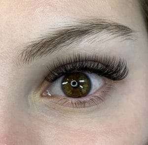 Soft glam eyelash extensions enhancing the eyes naturally.