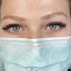 Detailed eyelash extension work showing precise lash application.